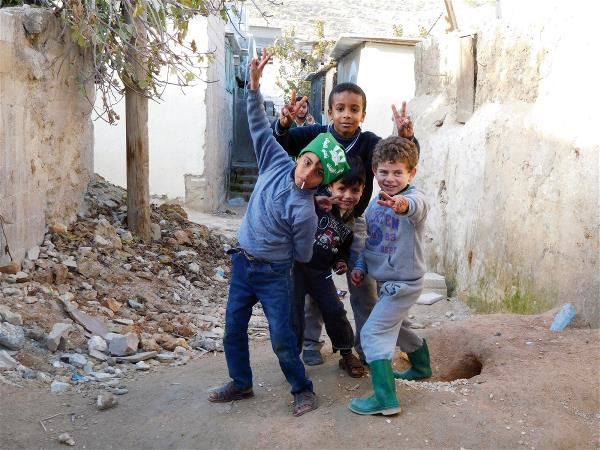 Although they come from different countries and have hard lives, when refugee children face a camera they smile brightly. The photo was taken in the Jerash Camp in Jordan.