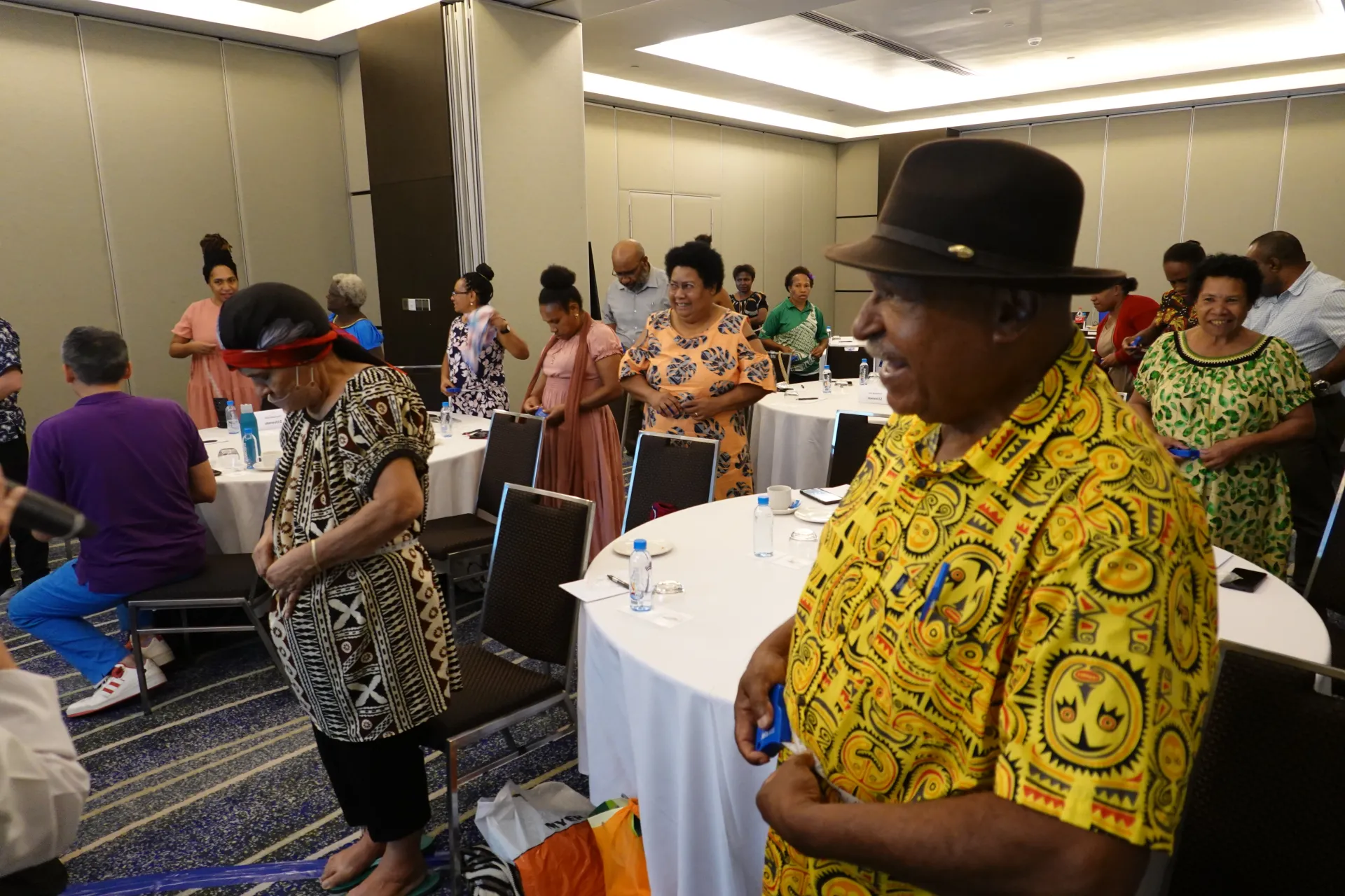 Participants at the nutrition seminar measure their waist circumference to assess abdominal obesity.