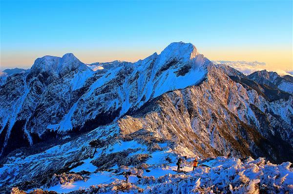 The snowy Main Peak and East Peak of Yushan at sunset.